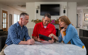 Total Comfort HVAC technician meeting with homeowners