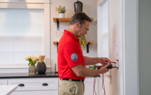 Electrician repairing an outlet